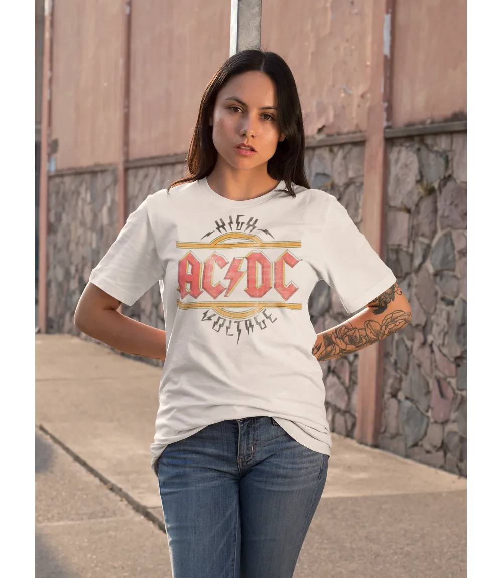 Woman wearing Unisex short sleeve white t-shirt featuring official AC/DC vintage style logo in the iconic red and yellow with the text High Voltage  and lightning bolts / Retro Tees