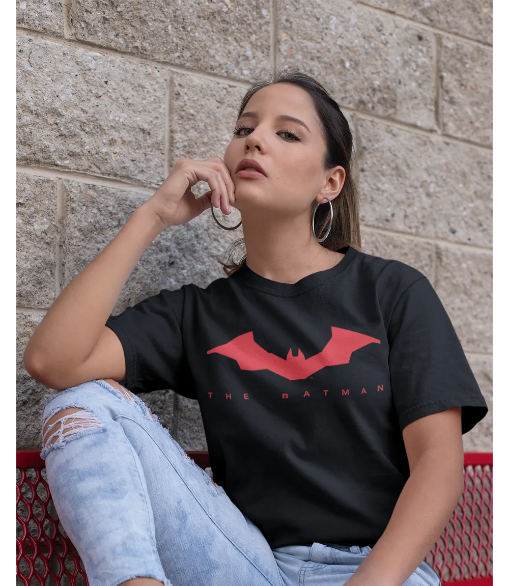 Woman wearing Unisex short sleeve black t-shirt featuring official DC Comics The BATMAN text in red and red Bat logo design / Retro Tees