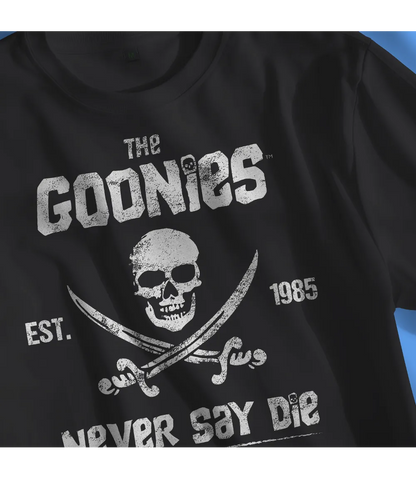 Close up of Unisex short sleeve black t-shirt featuring official Warner Bros The Goonies movie poster skull and cross swords design with the iconic text The Goonies, Never Say Die / Retro Tees