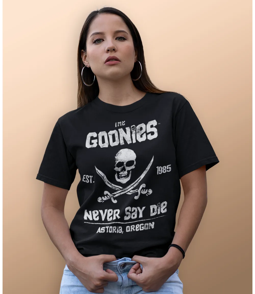 Woman wearing Unisex short sleeve black t-shirt featuring official Warner Bros The Goonies movie poster skull and cross swords design with the iconic text The Goonies, Never Say Die / Retro Tees