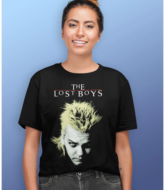Woman wearing Unisex short sleeve black t-shirt featuring official The Lost Boys 80s Vampire movie David design with The Lost Boys text / Retro Tees