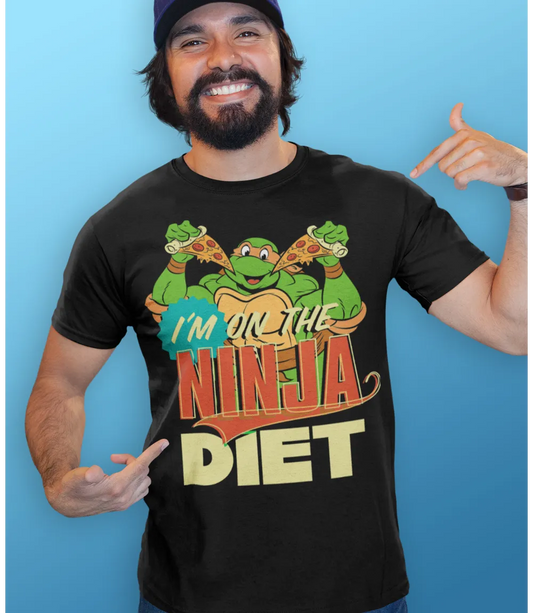Man wearing Unisex short sleeve black t-shirt featuring official Teenage Mutant Ninja Turtles Michelangelo with pizza design with I'm on the Ninja Diet text / Retro Tees