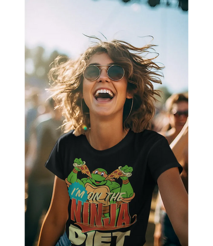 Woman wearing Unisex short sleeve black t-shirt featuring official Teenage Mutant Ninja Turtles Michelangelo with pizza design with I'm on the Ninja Diet text / Retro Tees